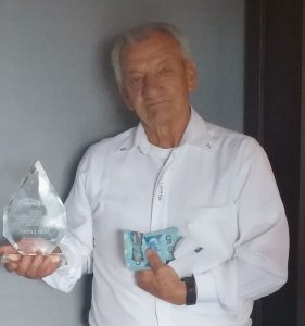 irvin Leroux with his TaxFighter Award and the $10 a Kelowna woman sent him
