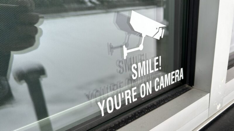 Sticker that reads "Smile! You're on camera!"