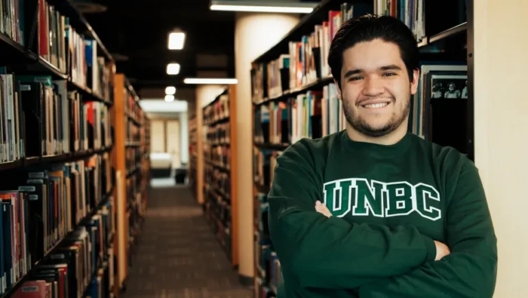 Second-generation UNBC grad walking the stage as Valedictorian