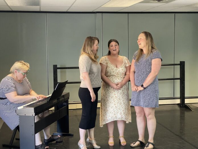Photo of performers singing opera