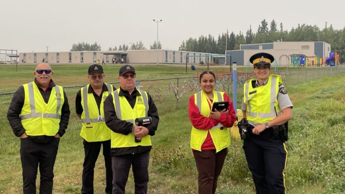 RCMP officers and volunteers outside Blackburn Elementary School
