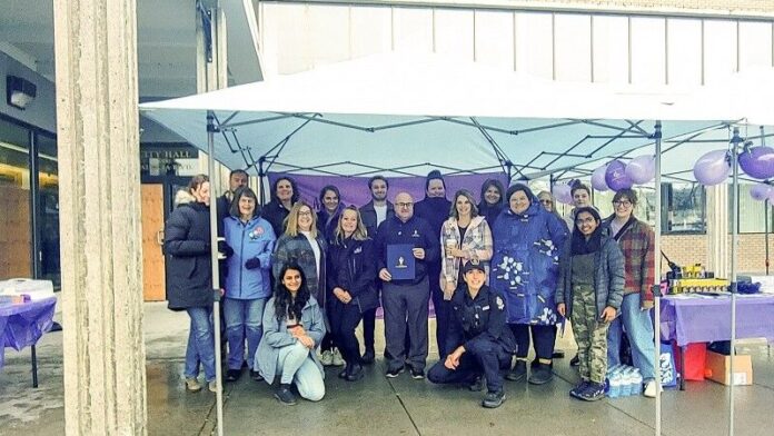 VAWIR committee standing with the signed proclamation document